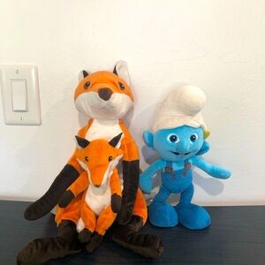 Stuffed  fox and Smurf.